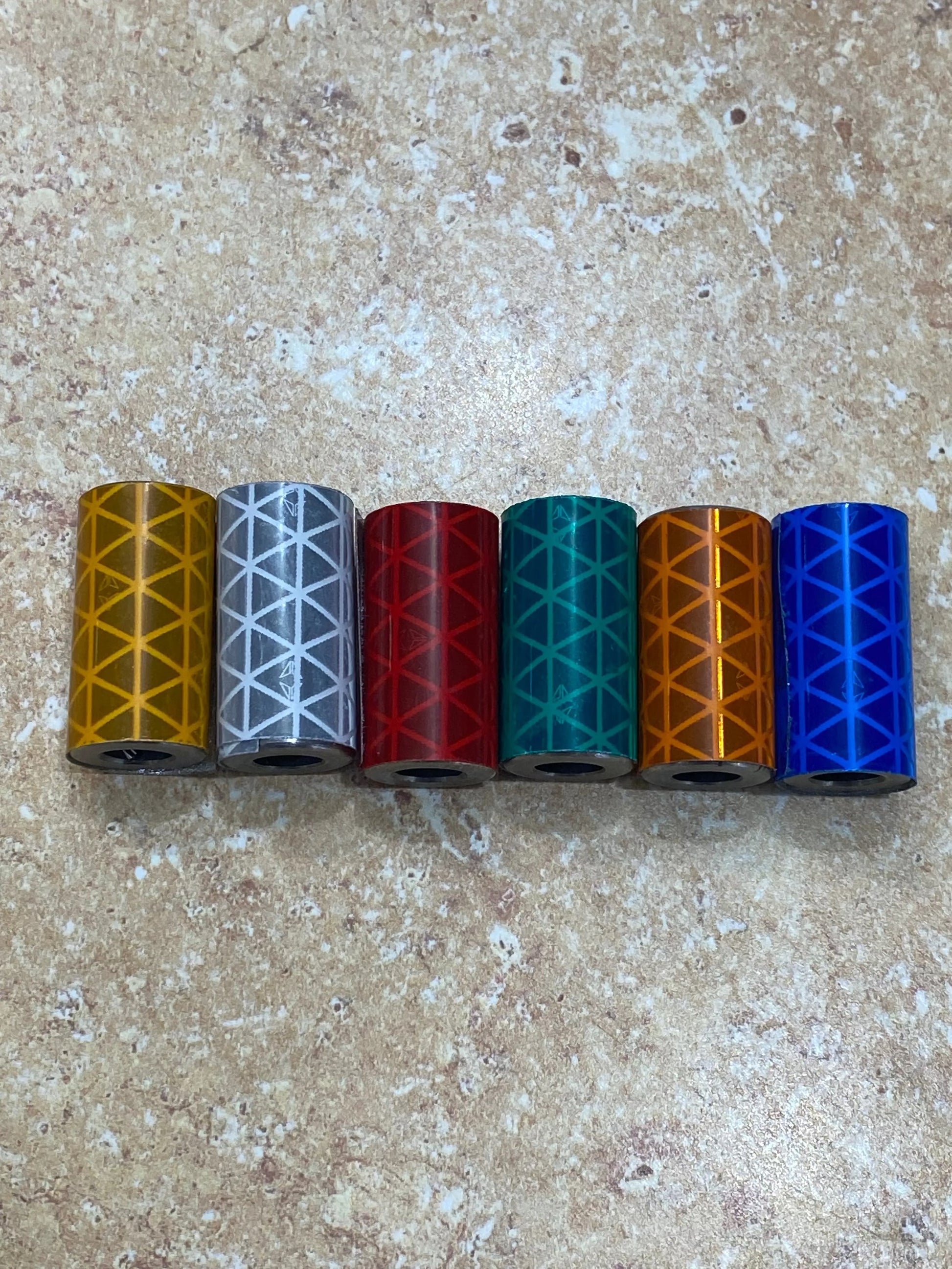 Six Knightmare Shoelace Running Weights in yellow, silver, red, teal, orange, blue with geometric lattice pattern.
